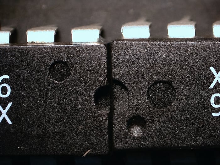 Two counterfeit X2212P ICs from one lot showing mismatched mold indent counts and shapes