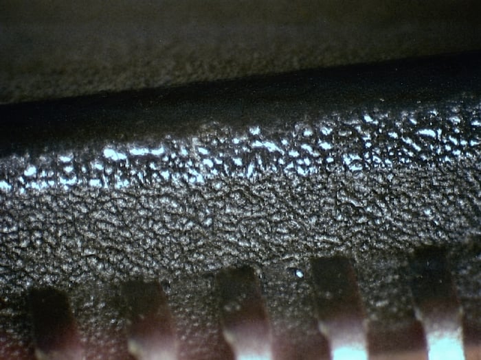 HD61602R edge showing a shiny blacktopped top surface against a duller original finish