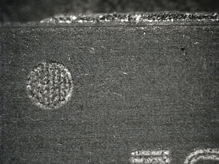 Same TC58FVT160AFT-70 after acetone wash showing light sanding marks and the original surface beneath the coating